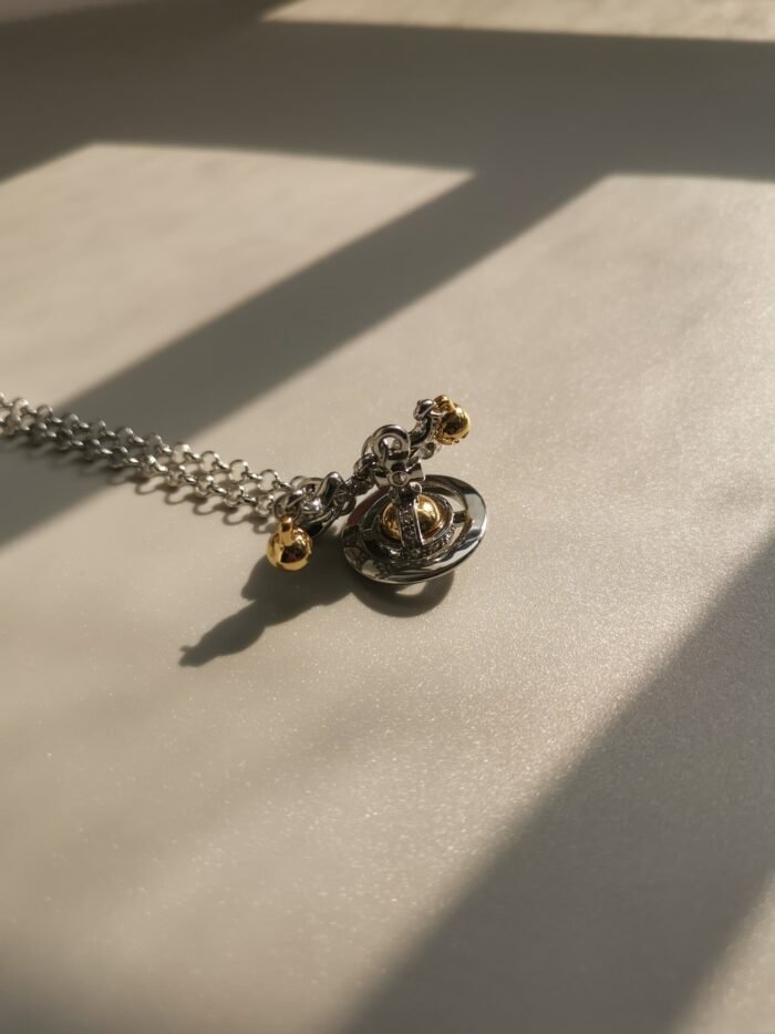 20E25C36-E6A0-409B-8D2A-D55D1C7F9FB3.jpg Silver and gold bow orb necklace (with box)